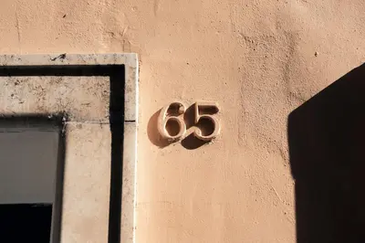 a sign on the side of a building with the number six at The Rubens Spagna in Rome