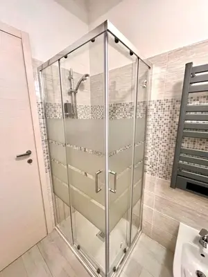 a glass shower in a bathroom with a sink at Pigneto Holiday Home in Rome