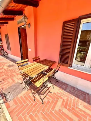 a group of chairs and a table on a patio at Pigneto Holiday Home in Rome