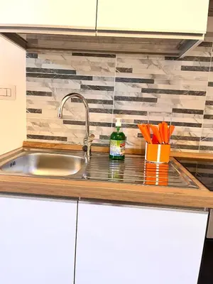 a kitchen counter with a sink and a counter top at Pigneto Holiday Home in Rome