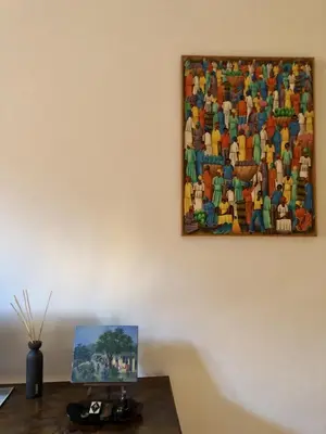 a painting hanging on a wall next to a table at 7550rome P&J's cozy Trastevere Apartment in Rome