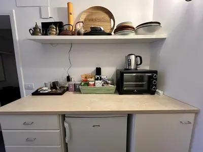 a kitchen with a counter top with a microwave at 7550rome P&J's cozy Trastevere Apartment in Rome