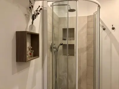 a shower with a glass door in a bathroom at 7550rome P&J's cozy Trastevere Apartment in Rome