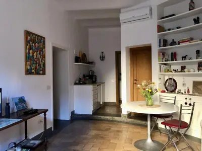 a kitchen with a table and chairs in a room at 7550rome P&J's cozy Trastevere Apartment in Rome