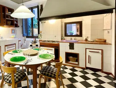 a kitchen with a table with green plates on it at Very Special Place in the heart of Rome in Rome