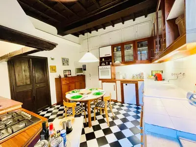 a kitchen with a table and a checkered floor at Very Special Place in the heart of Rome in Rome