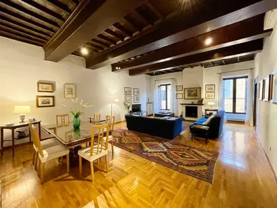a living room with a blue couch and a table at Very Special Place in the heart of Rome in Rome