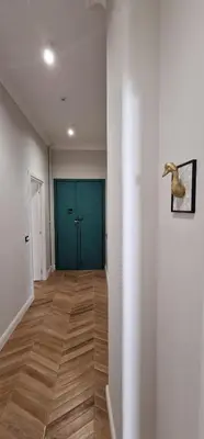 an empty room with a hallway with a blue door at LeChiaviDiCasa - Via Camilla in Rome