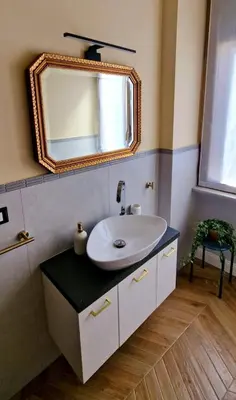 a bathroom with a sink and a mirror on the wall at LeChiaviDiCasa - Via Camilla in Rome