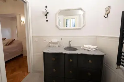 a bathroom with a sink and a mirror at Piazza Navona Ivy Retreat- Under the Roman Light in Rome