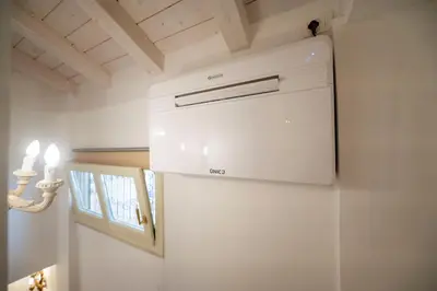 a white refrigerator in a kitchen with a ceiling at Piazza Navona Ivy Retreat- Under the Roman Light in Rome