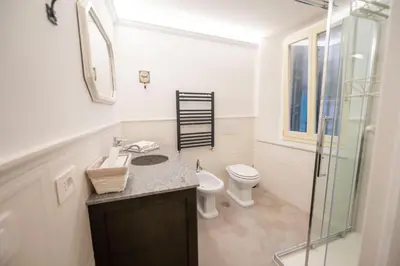 a bathroom with a toilet and a sink and a shower at Piazza Navona Ivy Retreat- Under the Roman Light in Rome