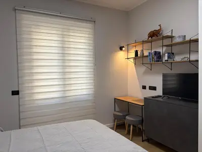 a bedroom with a bed and a desk and a window at Masonber trastevere centro Wi-Fi free balcone metro in Rome