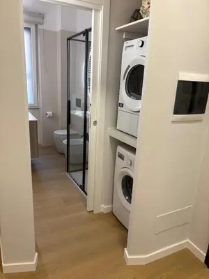 a bathroom with a washing machine and a washer and dryer at Masonber trastevere centro Wi-Fi free balcone metro in Rome