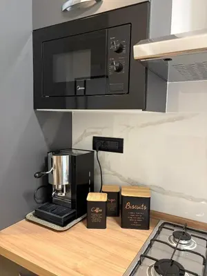 a kitchen counter with a coffee maker and a microwave at Masonber trastevere centro Wi-Fi free balcone metro in Rome