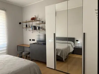 a bedroom with a glass partition with a bed and a desk at Masonber trastevere centro Wi-Fi free balcone metro in Rome