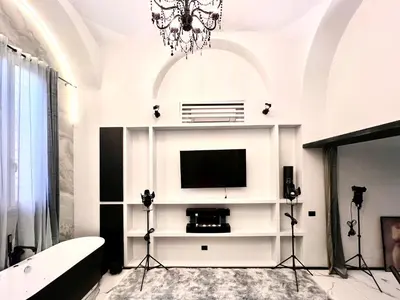a living room with a tv on a white wall at Romantic Rome Suite Aureliana in Rome
