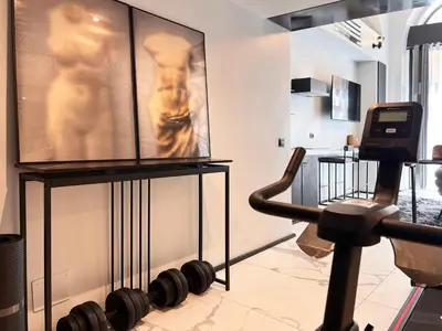 a room with a gym with a picture on the wall at Romantic Rome Suite Aureliana in Rome