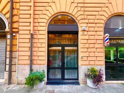 a building with a black door and two windows at Romantic Rome Suite Aureliana in Rome