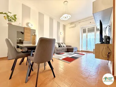 a living room with a table and chairs and a couch at San Giovanni - Minerva House in Rome