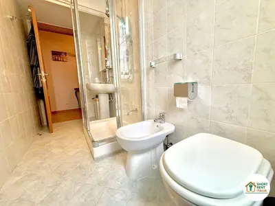 a bathroom with a toilet and a shower and a sink at San Giovanni - Minerva House in Rome