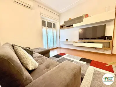 a living room with a couch and a flat screen tv at San Giovanni - Minerva House in Rome
