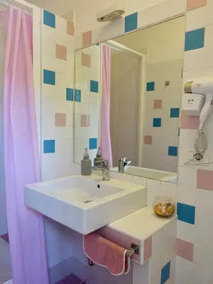 a bathroom with a sink and a pink shower curtain at PiccoloPrincipeAirbnb - Saint Peter area in Rome