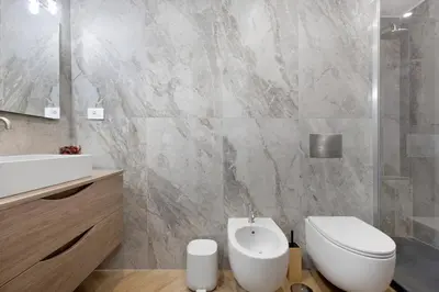 a bathroom with a white toilet and a sink at La Dimora di Piazza Mazzini in Rome