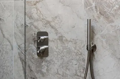 a glass shower door with a metal handle on a wall at La Dimora di Piazza Mazzini in Rome