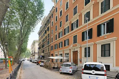 a street with cars parked in front of a building at La Dimora Luxury Piazza Mazzini in Rome