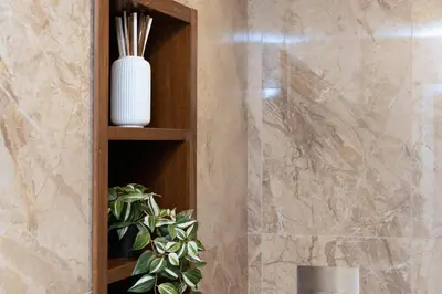 a wooden shelf in a bathroom with a plant at La Dimora Luxury Piazza Mazzini in Rome