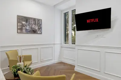 a waiting room with chairs and a tv on the wall at La Dimora Luxury Piazza Mazzini in Rome