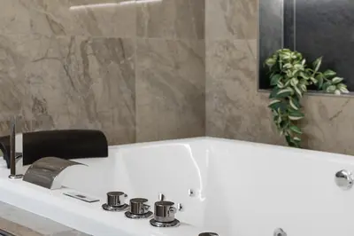 a bathroom with a white tub and a sink at Piazza Mazzini Suite con Vasca Idromassaggio in Rome