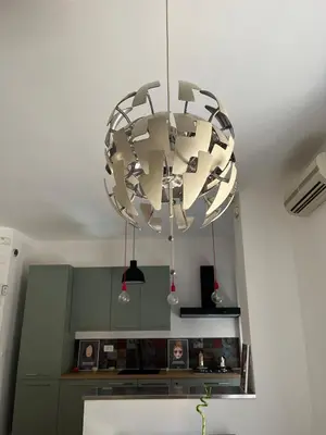 a large chandelier hanging from the ceiling in a kitchen at Terni 74 V&B Rock House in Rome