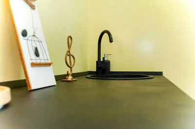 a kitchen with a sink and aaucet on a counter at Volpetti Experience-Suite in Vatican City in Rome