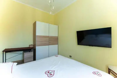a bedroom with a bed and a flat screen tv at Volpetti Experience-Suite in Vatican City in Rome