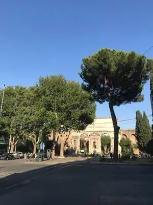 a street in front of a building with trees at Centralissima Collegatissima in Rome