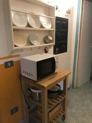 a microwave on a table with plates and bowls at Centralissima Collegatissima in Rome