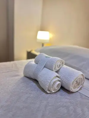 two rolled towels sitting on top of a bed at San Pietro Charme in Rome