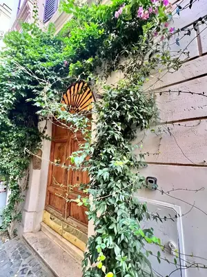 a wooden door with a bunch of flowers at San Pietro Charme in Rome