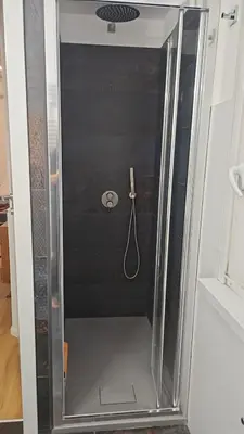 a shower with a glass door with a hose at Mina's House in Rome