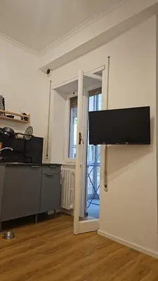 a living room with a flat screen tv on a wall at Mina's House in Rome