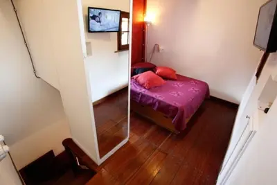 a small room with a bed and a mirror at 931 Rome Montefiore apartment in Rome