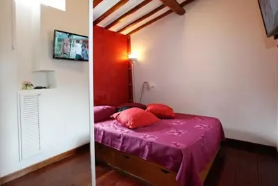 a bedroom with a bed with a purple comforter at 931 Rome Montefiore apartment in Rome