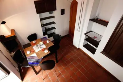 a dining room with a table and black chairs at 931 Rome Montefiore apartment in Rome