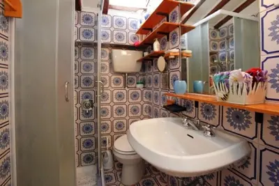 a bathroom with a sink and a toilet and a mirror at 931 Rome Montefiore apartment in Rome
