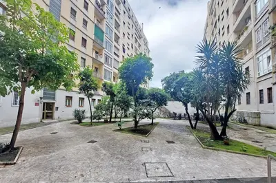 a courtyard with trees in front of a building at Brand New Modern Apt 2 Stops to Colosseum in Rome