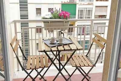 a table with two chairs and mugs on a balcony at Brand New Modern Apt 2 Stops to Colosseum in Rome