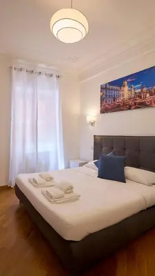 a bedroom with a large bed with two towels on it at Imperial Forum House in Rome