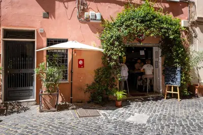 a group of people sitting at a table outside a building at Imperial Forum House in Rome